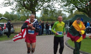 jon olsen from Modesto with american flag looking serious in Netherlands