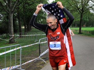 jon olsen from Modesto with american flag winner of the 24 hour race in Netherlands